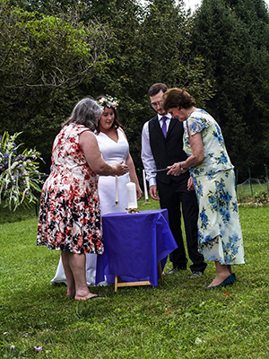 Mary Monfreda & Bev Daniels lighting the individual candles