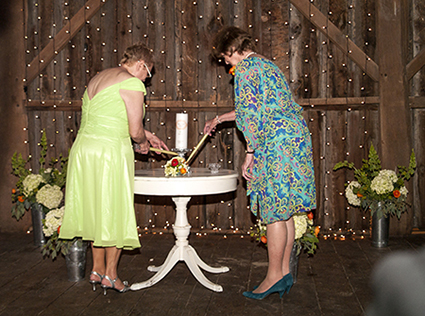 Mother and Grandmother lighting wedding candles